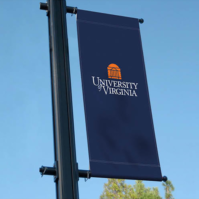 A UVA blue light pole banner with the University logo on it. On the homepage, clicking on this takes you to to environmental landing page.